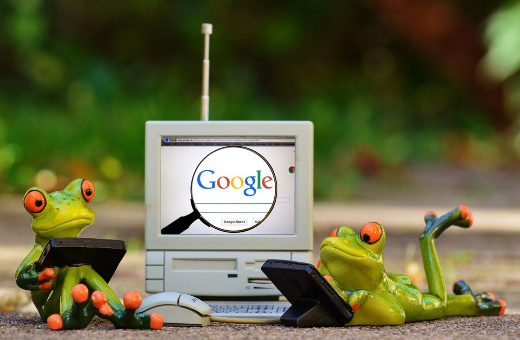 Illustration humoristique de deux grenouilles utilisant un ordinateur et un smartphone
